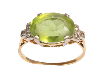 Lot 4 - A Peridot and Diamond Ring, circa 1930, the oval cut peridot to shoulders each set with three...