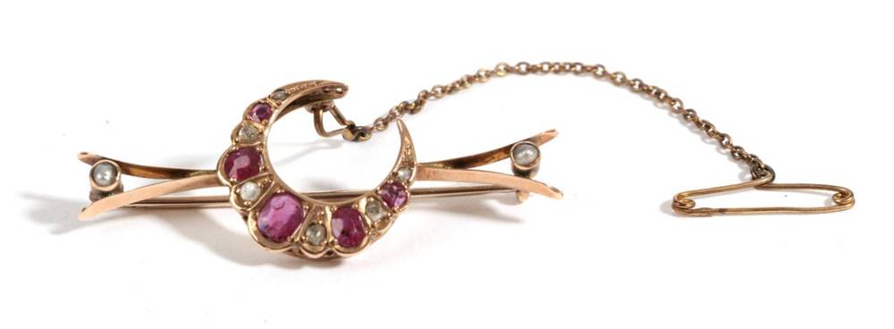 Lot 5 - A Ruby, Diamond and Pearl Crescent Brooch, the graduated oval rubies alternate with old cut...