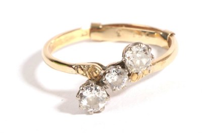 Lot 12 - A Diamond Three Stone Ring, an old cut diamond flanked by two larger old cut diamonds, in a...