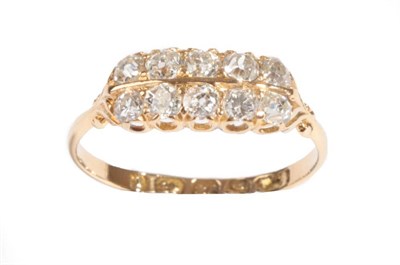 Lot 20 - An 18 Carat Gold Diamond Ten Stone Ring, the old cut diamonds in two rows, in yellow claw settings