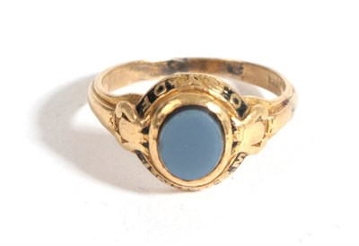 Lot 23 - An Agate Memorial Ring, an oval horizontally banded agate within a frame with black enamel to spell