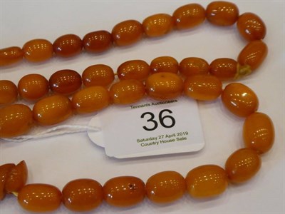 Lot 36 - An Amber Coloured Necklace, graduated polished beads of varying degrees of opacity and colour, from