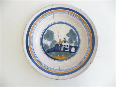 Lot 245 - A Faience Circular Dish, French or Spanish, late 18th/early 19th century, painted in blue ochre and