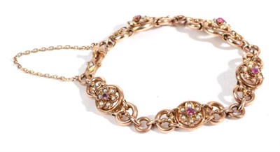 Lot 38 - An Early 20th Century Ruby and Seed Pearl Bracelet, round cut rubies within borders of seed pearls