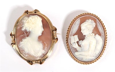 Lot 46 - A Cameo Brooch, depicting a lady reading with a ruffle collar, measures 4.7cm by 6.1cm; and A Cameo