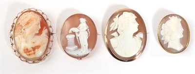 Lot 49 - Four Cameo Brooches; one depicting a maiden laying flowers on a pillar, in a simple oval frame,...