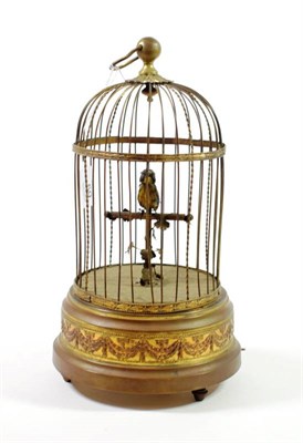 Lot 59 - A Singing Bird Automaton, late 19th/early 20th century, in a domed gilt wirework cage on a circular