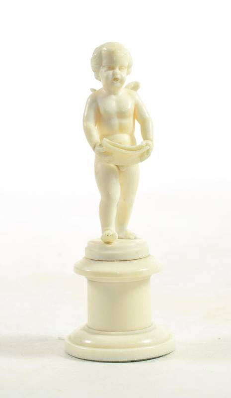 Lot 60 - A Carved Ivory Figure of a Singing Putto, probably Dieppe, late 19th century, standing holding...