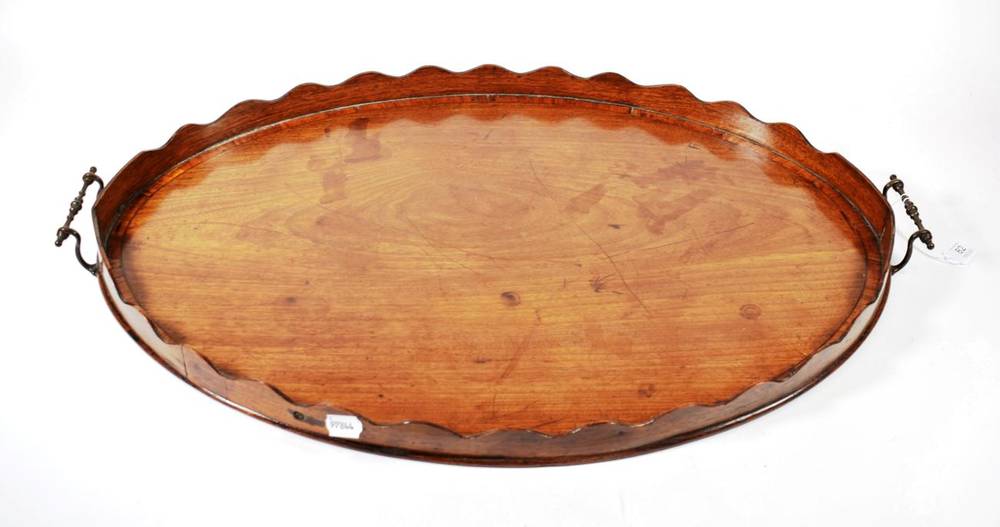 Lot 82 - A George III Mahogany and Tulipwood Banded Oval Tray, early 19th century, the moulded gallery...
