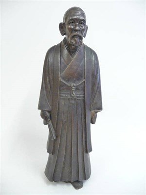 Lot 251 - A Japanese Brown Stoneware Figure of a Man, Meiji period, the bearded figure standing in...