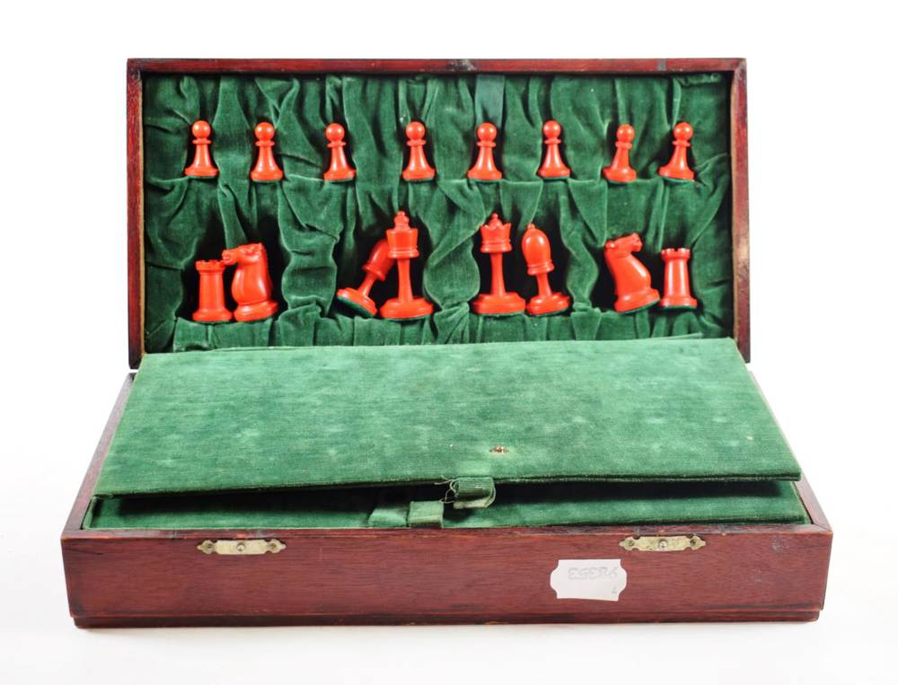 Lot 108 - A Stained and Natural Ivory Chess Set, circa 1900, kings 6.5cm high, contained in a chess board...