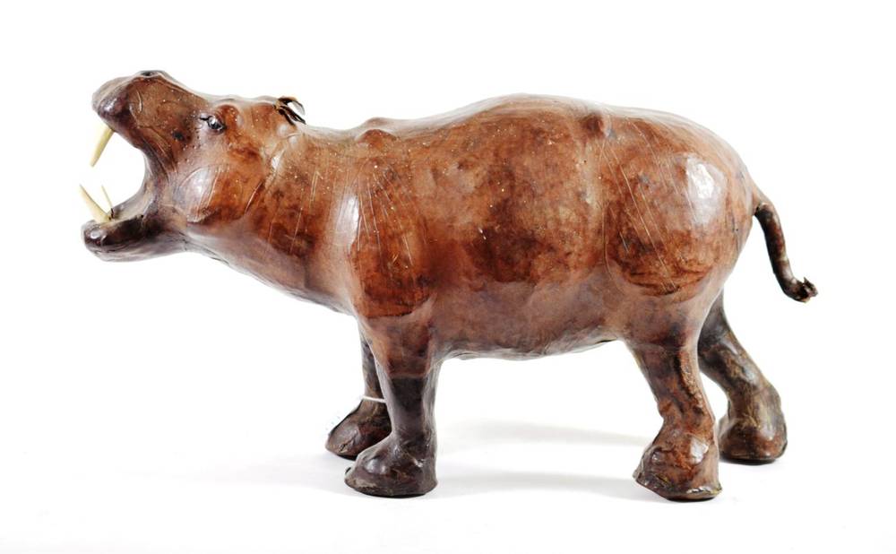 Lot 111 - A Leather Clad Model of a Hippopotamus, 20th century, standing four square with bone teeth,...
