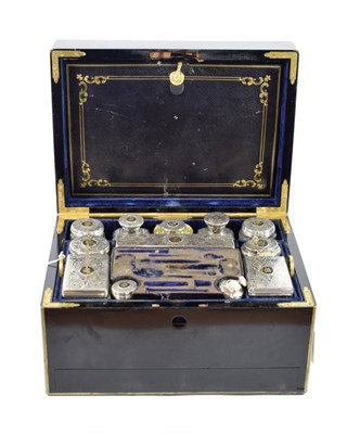 Lot 112 - A Victorian Brass Bound Ebonised Travelling Vanity Case, containing an assortment of parcel...