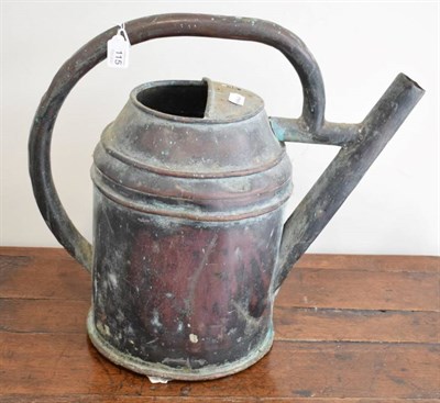 Lot 115 - A Copper Watering Can, of ribbed cylindrical form with overhead handle, 42cm high