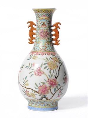 Lot 254 - A Chinese Porcelain Vase, early 20th century, with mythical beast handles, painted in famille...