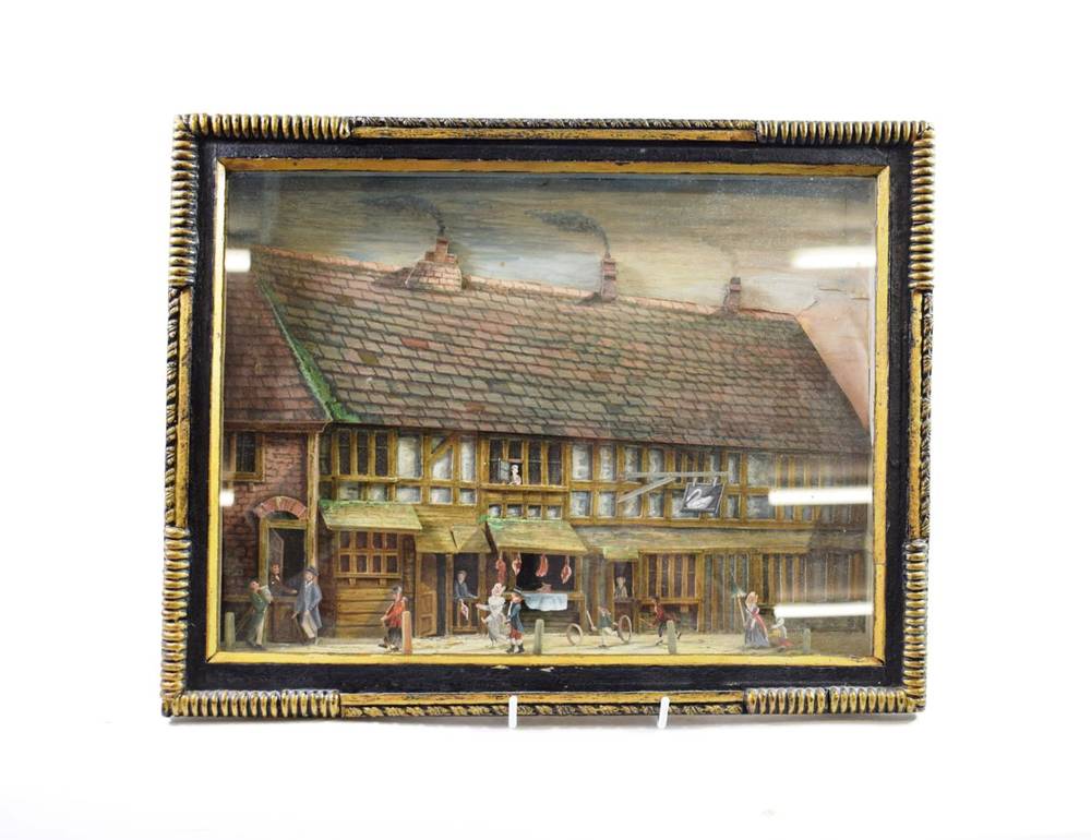 Lot 130 - ^ A Cut and Painted Wood Diorama, late 19th century, as a street scene with figures before The Swan