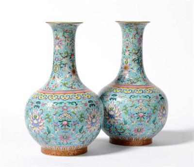 Lot 255 - A Pair of Chinese Porcelain Bottle Vases, 20th century, painted in famille rose enamels with...