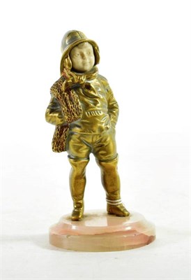 Lot 144 - Georges Omerth: A Gilt Bronze and Ivory Figure of a Boy Fisherman, standing wearing a sou'wester, a