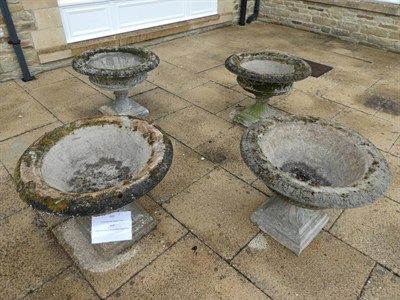 Lot 187 - A Set of Four Reconstituted Stone Garden Urns, of campana form with basket weave bands on leaf...