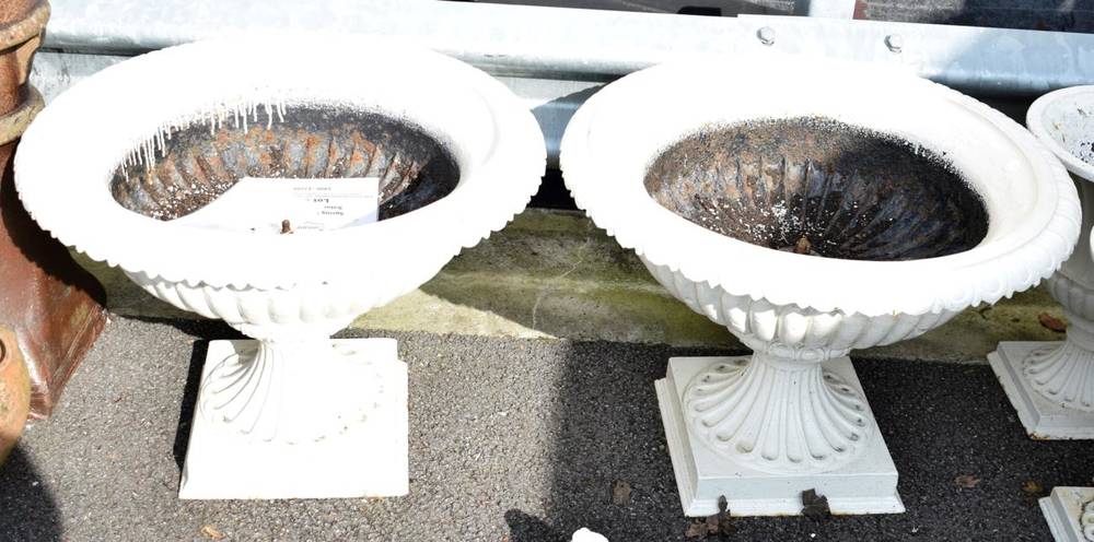 Lot 188 - ~ A Pair of Cream Painted Cast Iron Garden Urns, of fluted campana form, on square bases, 73cm high