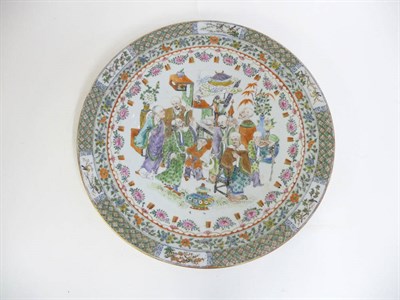 Lot 264 - A Cantonese Porcelain Charger, mid 19th century, painted in famille rose enamels with figures...