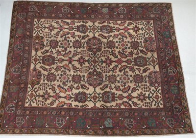 Lot 255 - Indian Carpet, circa 1920 The pale camel field with an allover design of large flowerheads,...