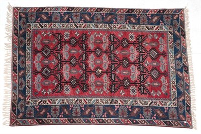 Lot 274 - ~ Dosemalti Carpet West Turkey, modern The crimson latch hook lattice field enclosed by indigo...