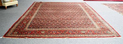Lot 279 - Mashad Carpet North East Iran, circa 1920 The raspberry floral lattice field enclosed by borders of