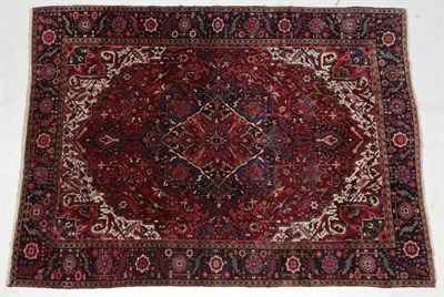Lot 283 - Heriz Carpet Iranian Azerbaijan, circa 1940 The blood red field of vines around a flowerhead...