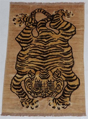 Lot 284 - Tiger Rug Nepal/Tibet, modern The soft camel field with stylised tiger, 182cm by 123cm