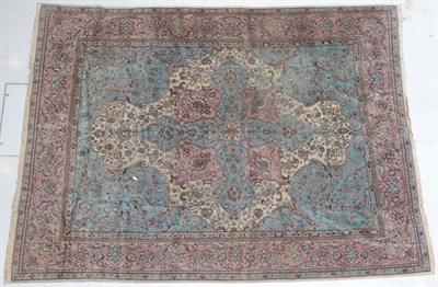 Lot 296 - Kirman Carpet South East Iran, 1950 The ivory field centred by a sky blue and coral pink...