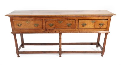 Lot 307 - ^ A Mid 18th Century Oak Low Dresser, the moulded top above three frieze drawers, on turned spindle