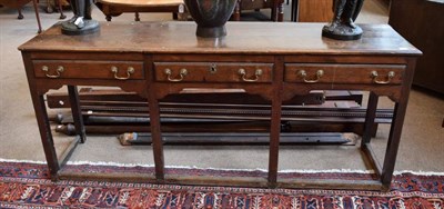 Lot 310 - A Mid 18th Century Oak Dresser, the moulded top above three narrow frieze drawers and shaped apron