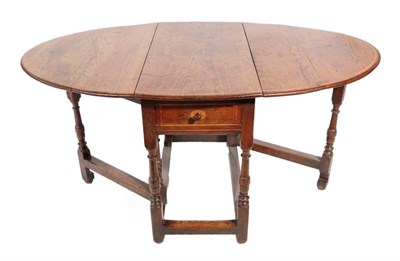 Lot 314 - ^ An Early 18th Century Oak Dining Table, later inlaid with an oval panel, with two hinged drop...