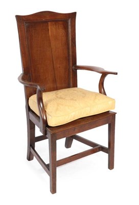 Lot 328 - ^ A George III Joined Oak Chair, early 19th century, the moulded back support above outswept...