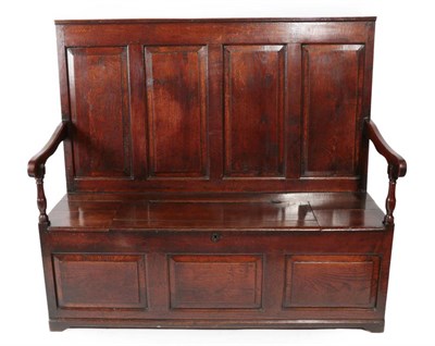 Lot 337 - A George III Joined Oak Box Settle, early 19th century, the back support with four fielded...