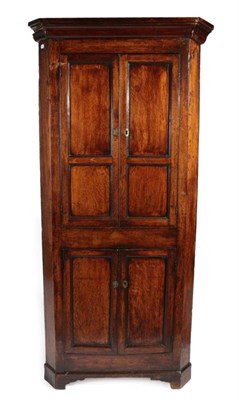 Lot 338 - A Mid 18th Century Joined Oak Free-Standing Corner Cupboard, the moulded cornice above cupboard...