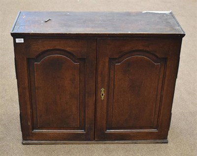 Lot 348 - An 18th Century Oak and Pine Sided Cupboard, with moulded cupboard doors enclosing eight small...