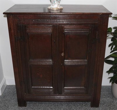 Lot 351 - A Joined Oak Cupboard, the later top above twin fielded panel doors enclosing shelves all...