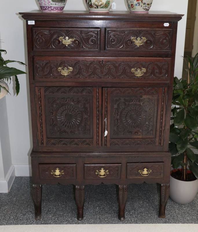 Lot 355 - A Carved Oak Chest on Stand, the upper section with two short above one long drawer with two...