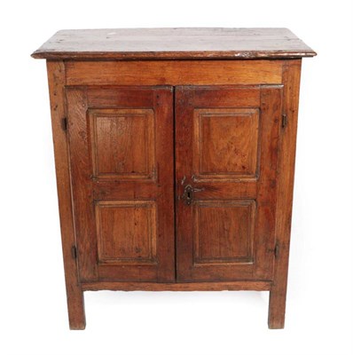 Lot 362 - ^ An 18th Century Joined Oak Cupboard, the boarded top above two cupboard doors with four...