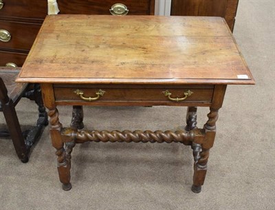 Lot 365 - An Oak Side Table, the moulded top above a long frieze drawer raised on spiral and block legs,...