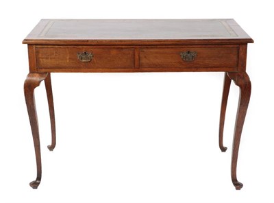 Lot 367 - ~ A Two-Drawer Oak Writing Table, the later green and gilt leather skiver above two frieze drawers