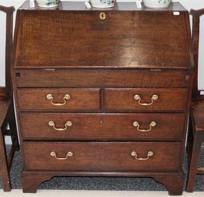 Lot 373 - A George II Oak and Chestnut Bureau, 2nd quarter 18th century, the fall front enclosing a...