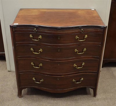 Lot 387 - A George III Mahogany Serpentine Front Chest of Drawers, late 18th century, with a fluted...