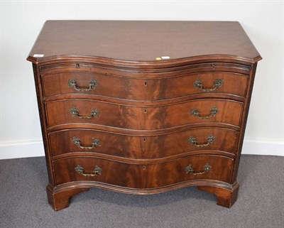 Lot 389 - A George III Style Mahogany Serpentine Shaped Chest of Drawers, the moulded top above a...