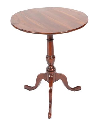 Lot 431 - ^ A George III Mahogany Fliptop Circular Tripod Table, late 18th century, on a turned vasiform...