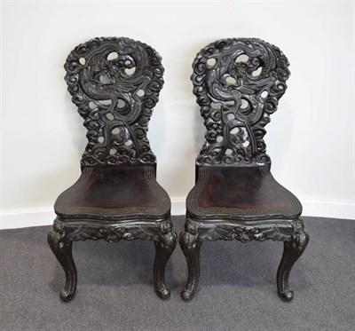 Lot 455 - A Pair of Japanese Softwood Carved Dining Chairs, late 19th/early 20th century, the foliate...