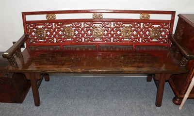 Lot 459 - A Chinese Softwood and Red Painted Bench, the pierced and gilded back support above a solid...