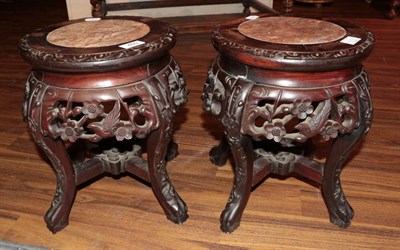 Lot 460 - A Pair of Chinese Carved Padouk Wood and Pink Marble Plant Stands, early 20th century, of...